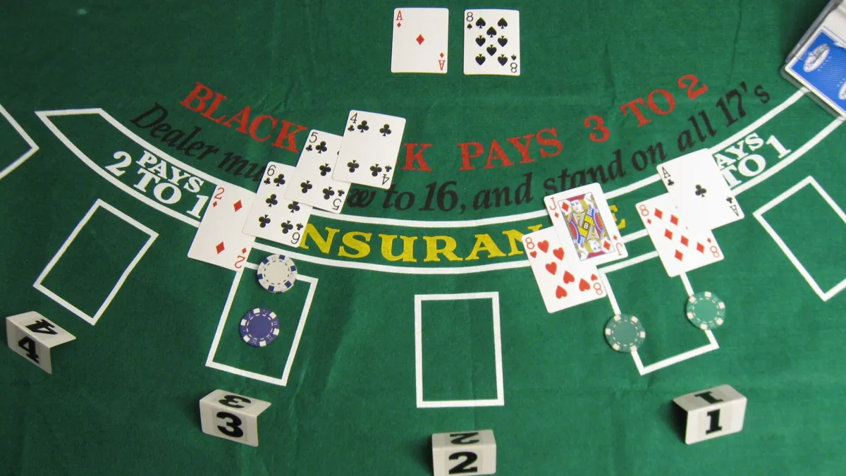 Blackjack dealer showing an ace above the insurance line with chips on the felt