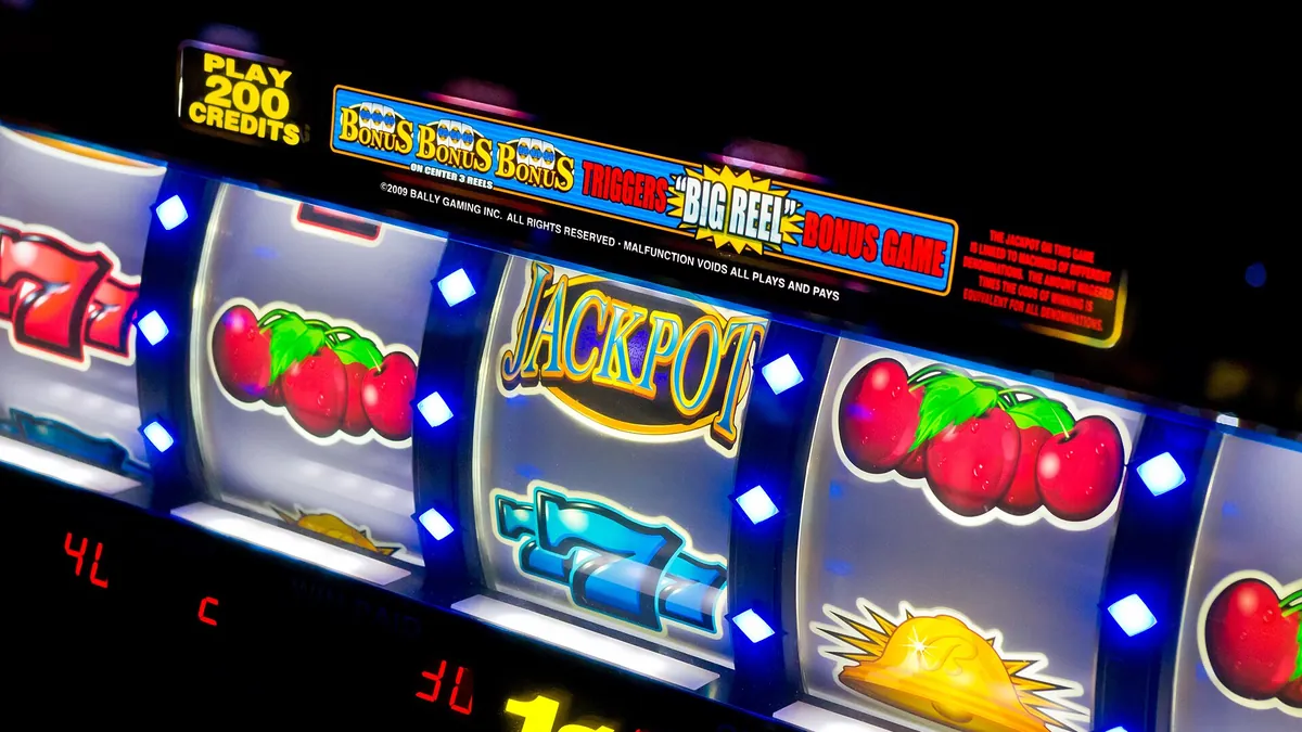 Close-up of spinning slot machine reels with cherries and jackpot symbols